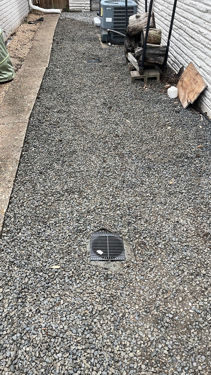 Catch basin drain installed in a gravel bed at a Richmond, TX home