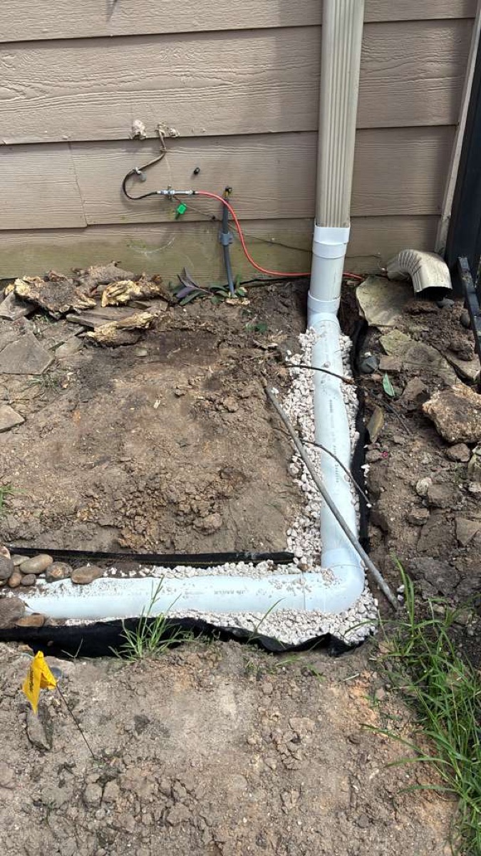 Downspout drain line extension installed at a Memorial, Houston home