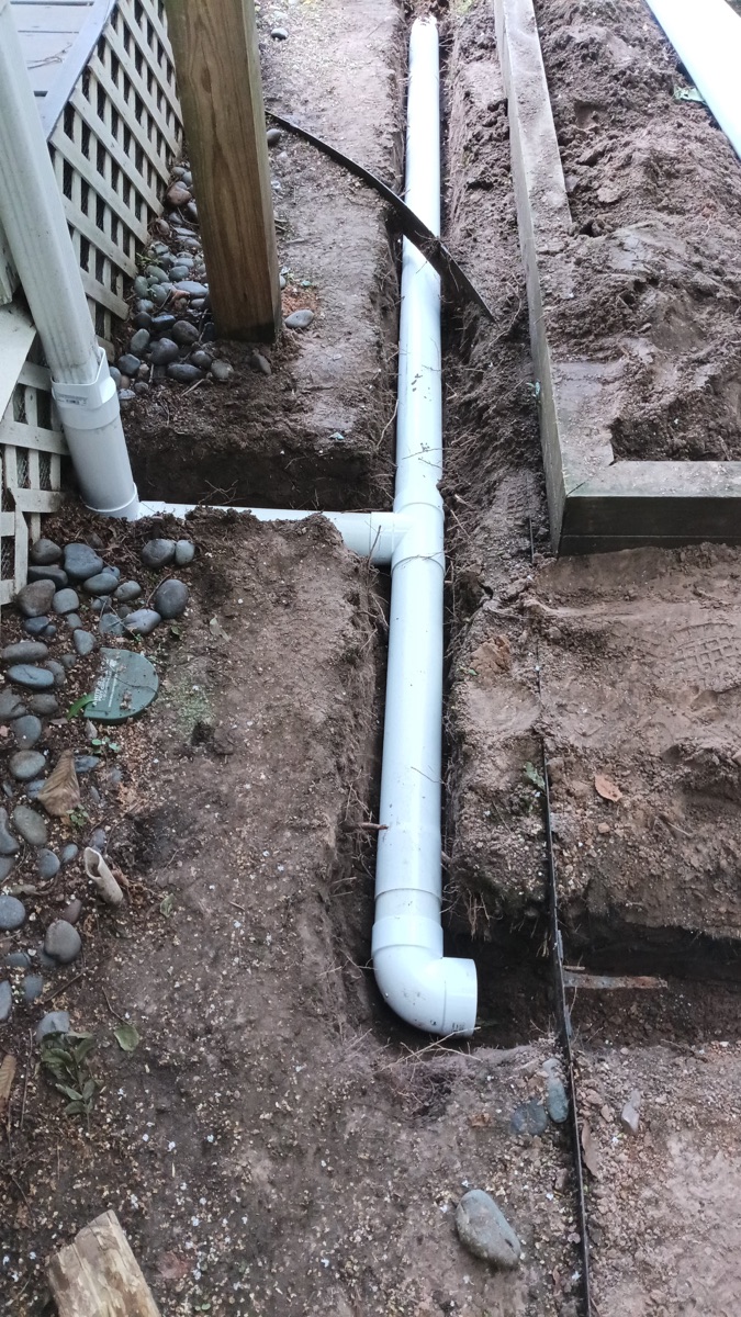 Downspout drain extension piping installed in a Meyerland, Houston yard