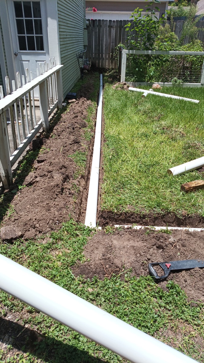 French drain installation in a Sugar Land, TX residential yard
